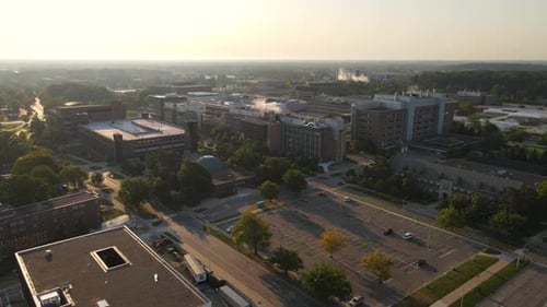 Buildings of Michigan State university with steaming chimneys, aerial drone view