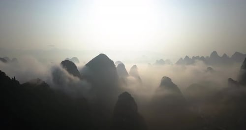 Karst Mountains Covered With Fog At Sunrise In Yangshuo,Guilin,China. - wide shot