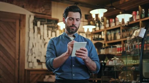 Restaurant Staff Member in Apron Taking Order Notes and Smiling at Camera