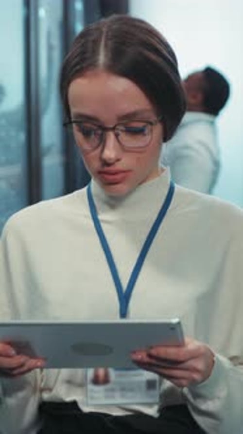 A Dedicated Businesswoman is Actively Engaged with Technology Within a Modern Office Environment