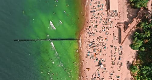 View from above sea and crowd on beach in summer.