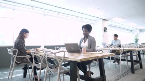 People Working on Laptops in Modern Office Space
