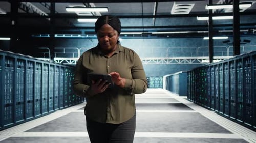 Software Developer Runs Equipment Checkups with Green Screen Tablet in Data Center
