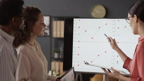 Employees Looking at Screen while Preparing for Conference