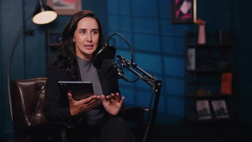 Portrait of Woman Financial Expert with Tablet Talks in Mic in Audio Studio
