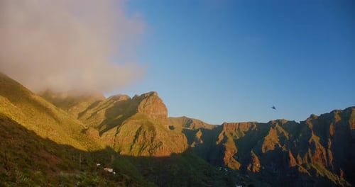 Beautiful mountain peak in clouds. Sunset on the gorge Mask or Masca village. Clouds descend on the