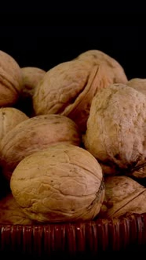 Many Whole Walnuts in Peel in Wicker Basket As Healthy Eating Example
