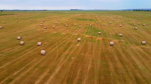 Hay Bales in Rural Field on Cloudy Day Aerial View