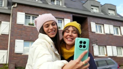 Joyful Young Women Friends Taking Selfie Video on a City Street