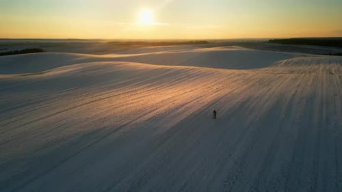 Aerial View Young Couple Embrace in the Rays of the Setting Sun in Winter