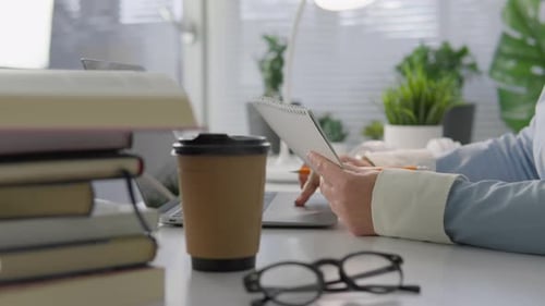 Adult Working, Using Laptop and Writing Notes