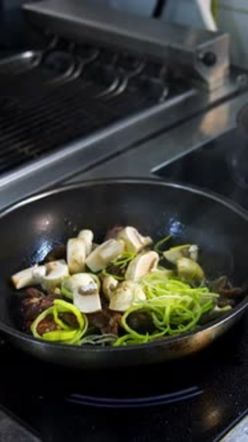 Mushrooms and Leeks being Cooked in a Frying Pan