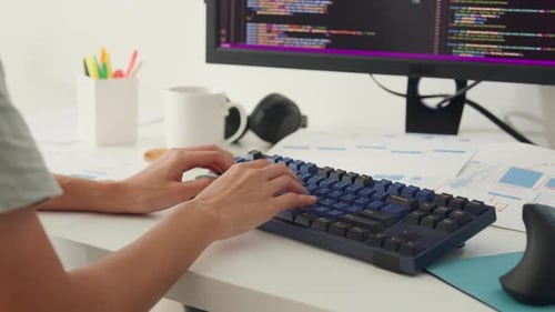 Close-up young Asia girl IT development programmer typing on keyboard coding programming.