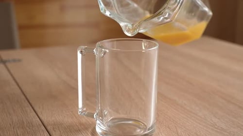 Fresh Orange Juice Poured Into Glass Mug