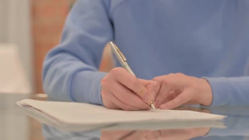 Close up of Young Woman Writing a Letter