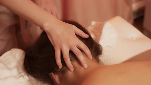 Woman Receiving Soothing Head Massage at Spa