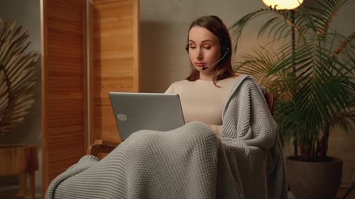 The Stress of the Deadline An Exhausted Freelance Woman with a Headset Tired After Working on a