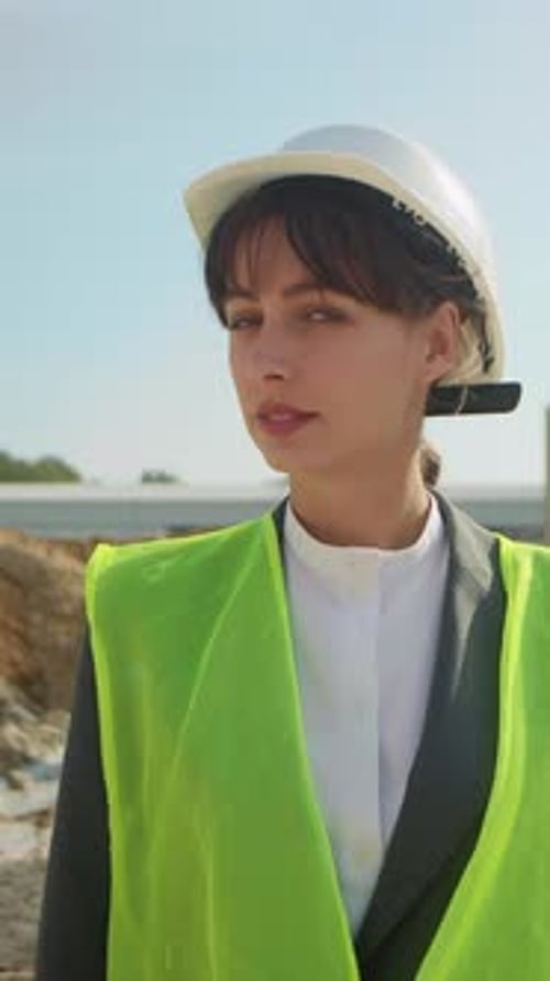 Closeup Portrait of Young Woman in White Protective Helmet Looking Away on Background of