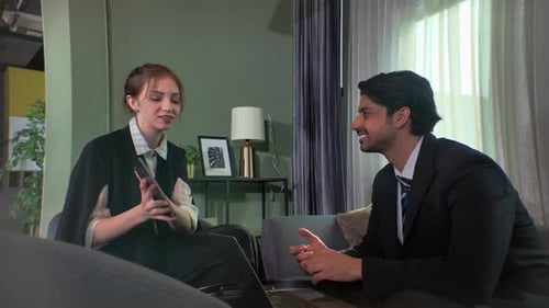 Business meeting in modern office between two professionals discussing documents