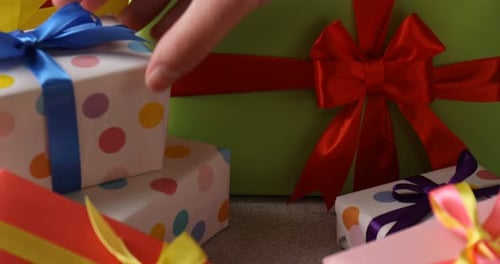Colorful Wrapped Gift Boxes Being Stacked Close Up