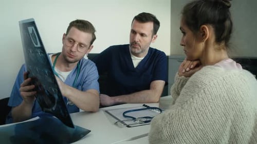 Doctors Discussing Medical Diagnosis with Patient
