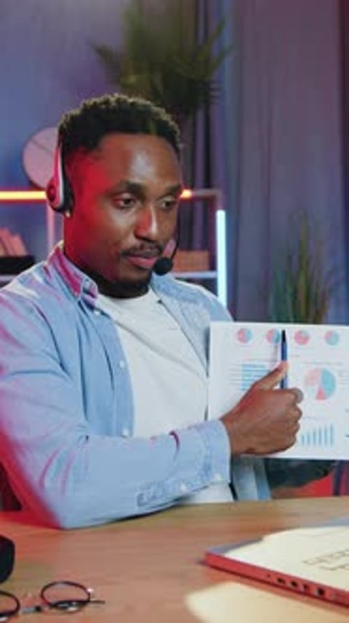 Adult Man Explaining Charts During Remote Meeting