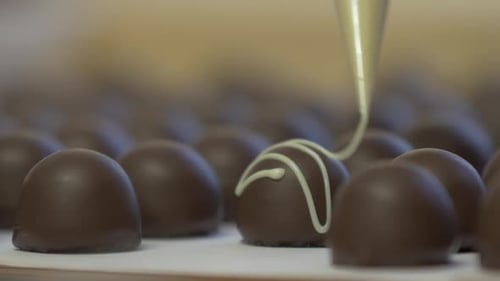 Pastry Chef Icing Chocolate Candies Close Up