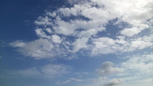 Clouds Time-Lapse Moving in Bright Blue Sky