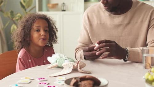 Father and Daughter Playing with Toys at Home