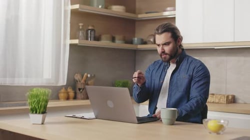 Man on Laptop Having Video Call at Home