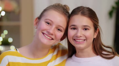 Two Smiling Girls Posing in Home Interior
