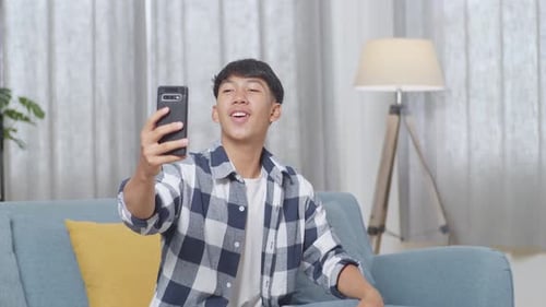 Smiling Young Man Video Calling on Mobile Phone