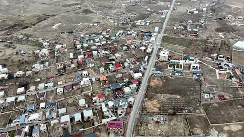 Aerial View of Rural Village and Country Road with Moving Cars