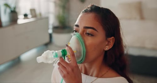 Woman Uses Nebulizer Treatment Mask Inside Home