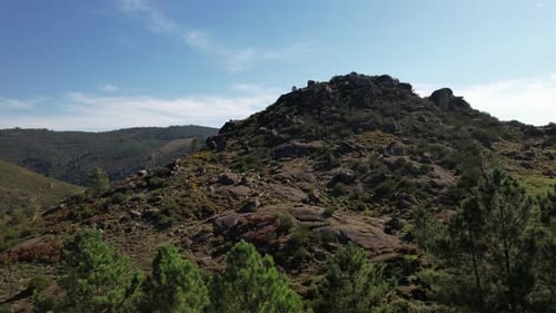 Scenic Aerial View of Sheep on Rocky Hillside