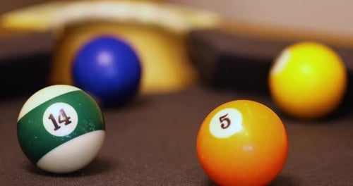 Selective Focus Of Multicolored Billiard Balls Roll On The Pool Table Surface.