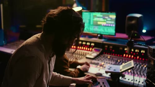 Skilled Musician Performing in Control Room at Studio and Recording Tracks