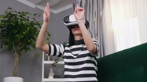 Woman Experiencing Virtual Reality Headset in Living Room