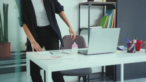 Young Woman Employee in a Medical Facial Mask Use Antiseptic Works in the Office Laptop Coronavirus