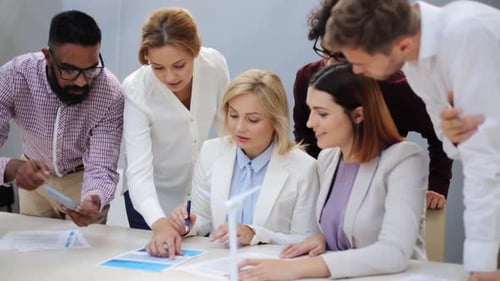 Team Discussing Sustainable Energy in Bright Office Setting