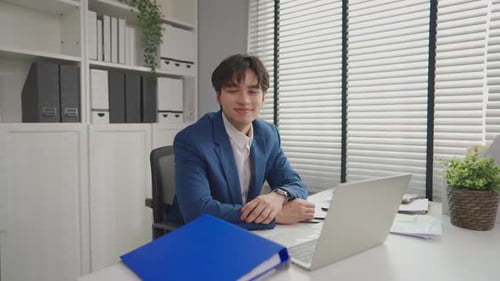 Portrait of Asian young businessman working in the office workplace.