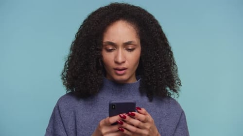Woman Looking at Smartphone with Confused Expression