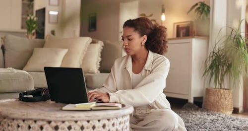 Young Woman Works on Laptop at Home