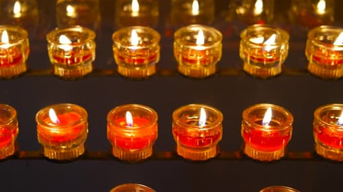 Illuminated Red Votive Candles Creating a Warm Ambiance in a Church Setting