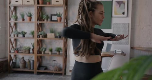 Woman Stretching Arms in Home Workout Space