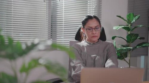 Woman Working on Laptop at Home Office