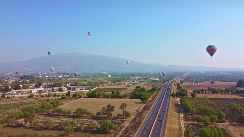 Aerial View of Highway and Hot Air Balloons