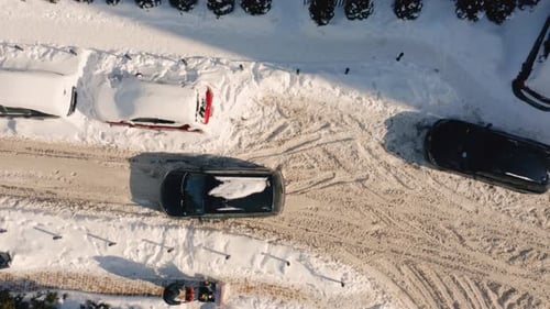 Snow Covered Street and Cars Aerial View From Above