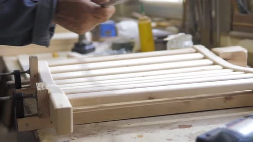 Adult Working With Wood And Tape Measure