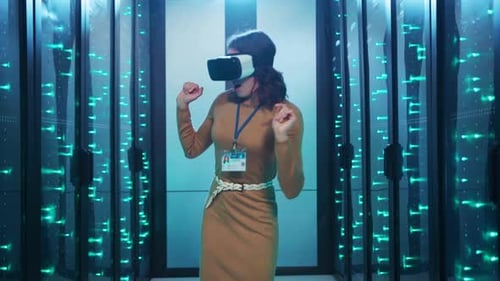 A Woman is Currently Wearing a Virtual Reality Headset While in a Server Room
